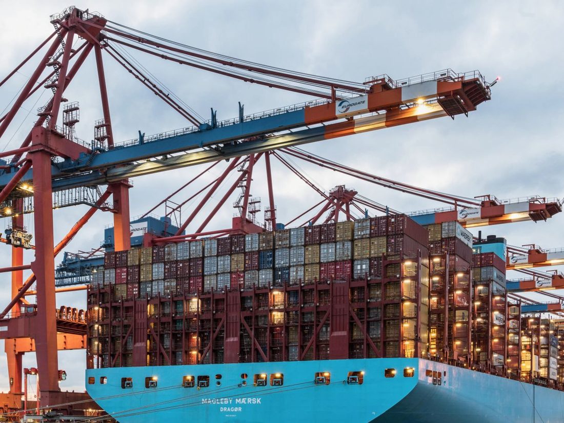 Container ship being loaded under port cranes